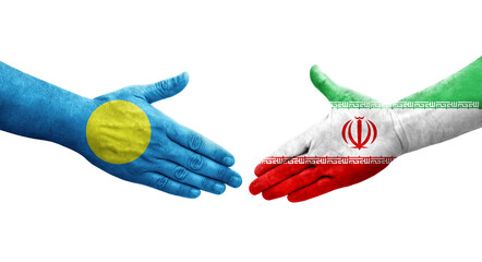 Handshake between Iran and Palau flags painted on hands, isolated transparent image.