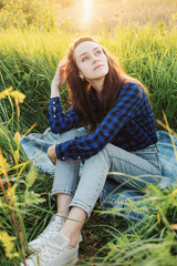 Portrait of a beautiful young woman on meadow