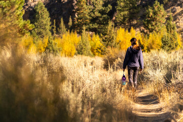 A woman hikes in the forest in the fall in Oregon