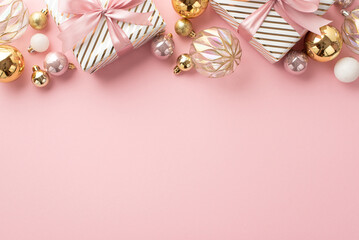 New Year concept. Top view photo of stylish present boxes with ribbon bows gold transparent and pink baubles on isolated light pink background with empty space