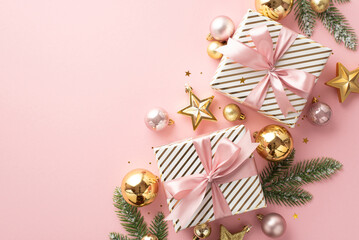 Christmas Eve concept. Top view photo of big gift boxes with ribbon bows pine branches in hoarfrost gold pink baubles star ornaments and confetti on isolated pastel pink background with copyspace