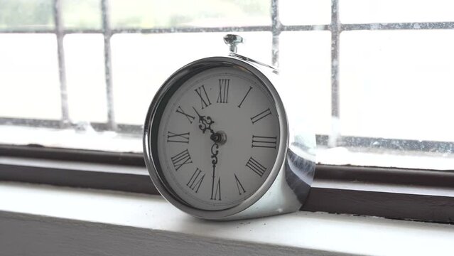 Silver Clock infront of Sunny Window