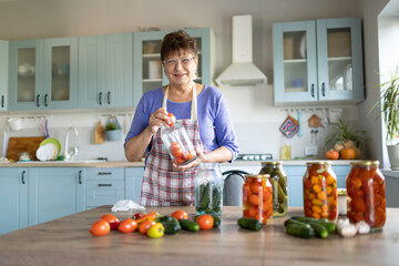 Woman in the kitchen canning vegetables