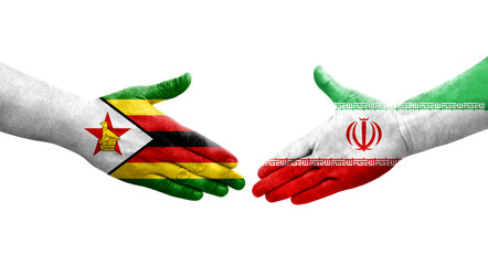 Handshake between Iran and Zimbabwe flags painted on hands, isolated transparent image.