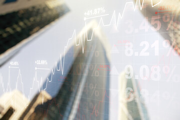 Double exposure of abstract financial graph on office buildings background, financial and trading concept