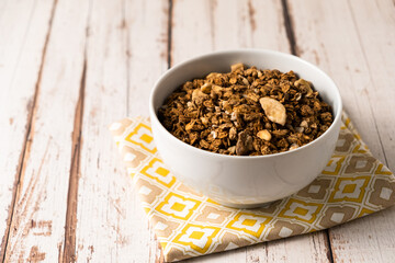 Chocolate breakfast cereal. Morning chocolate granola with dried banana on a black table.