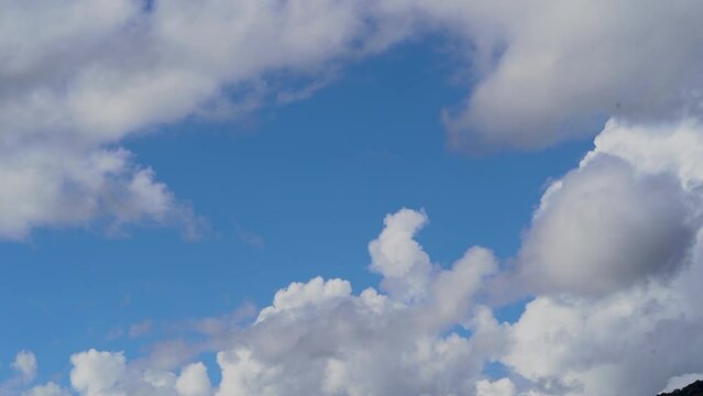Timelapse. Blue sky, white clouds. Puffy fluffy white clouds. Nature, weather. Background of white clouds.