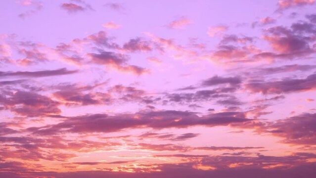Beautiful Sunset Sun Cirrus Clouds in Colorful Sky, Time Lapse, Slow Motion. Lilac Pink Orange Colored Sky with Clouds and Sun at Sunset. Multicolored Evening Sunset, Timelapse.