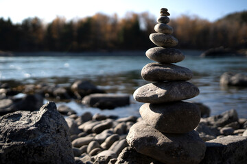 A pyramid of stones on the bank of the river. balance in nature.