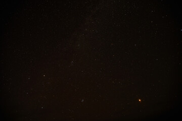 Dark night sky with stars above Arctic circle in autumn season.