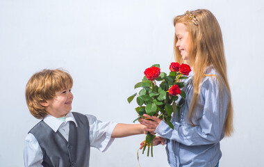 Little Boy with a rose for his teen girlfriend, romantic children, isolated on white background. Love concept.