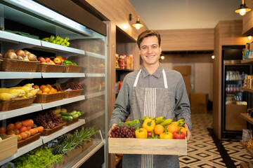 Portrait of a caucasian man working in a supermarket or retail shop and food on grocery products. Food shopping. People lifestyle. Business service. A staff worker