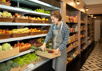 Portrait of a caucasian woman working in a supermarket or retail shop and food on grocery products. Food shopping. People lifestyle. Business service. A staff worker