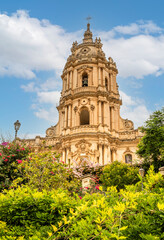Colorful flowers and plants with the beautiful Cathedral of S. Giorgio di Modica in the background
