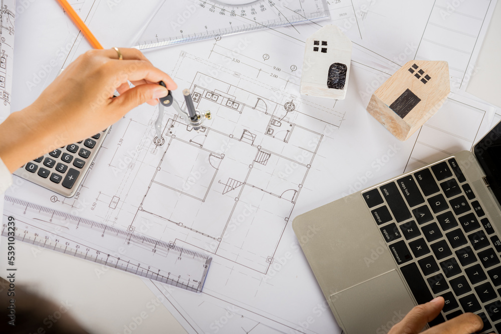 Poster architectural project workplace. architect typing laptop keyboard to review design of house before e