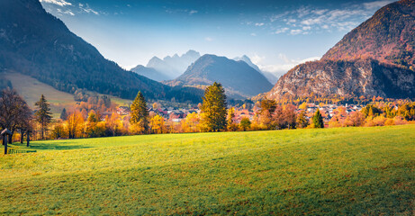 Bright autumn view of Triglav mountain range and Gozd Martuljek village on background. Splendid...