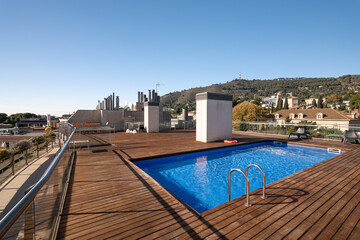 Swimming pool on roof top with clear blue sky at hill city area