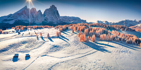 Panoramic winter view from flying drone of Alpe di Siusi village with Plattkofel peak on...