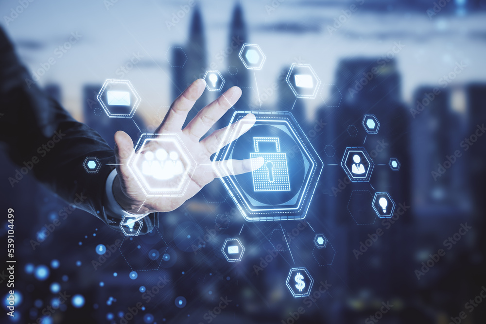 Poster close up of business man hand using abstract glowing padlock hologram on blurry city background. sec