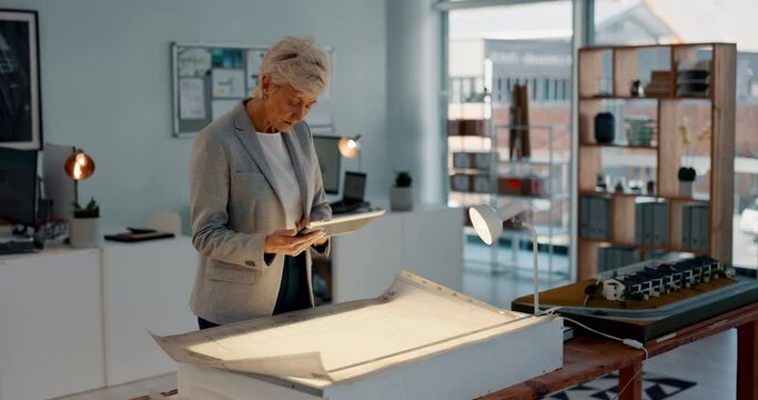 Tablet, architect and idea with a woman designer working on a blueprint in an architecture office. Engineer, creative and internet with a senior female employee at work, thinking about building plans