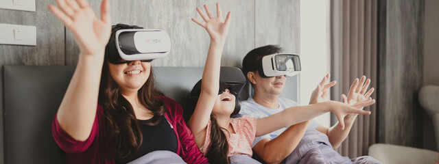 children family with mother and father home, happy and smile with virtual reality goggles technology together, person leisure lifestyle to having fun with digital video game by wearing headset