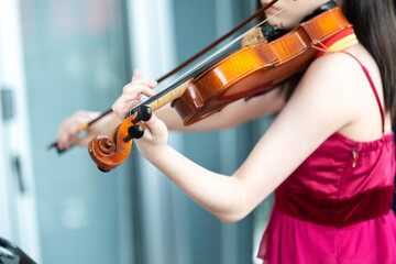 Violin close-up, Young woman playing the violin at home.