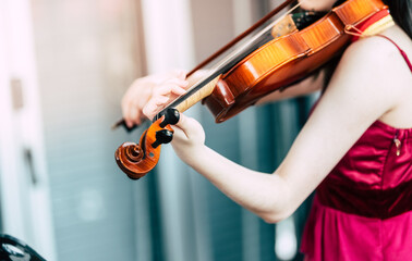 Violin close-up, Young woman playing the violin at home.