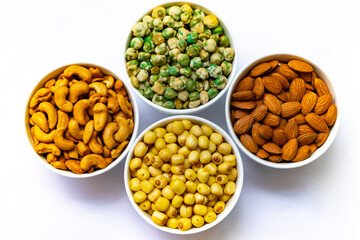 Grains in white bowl such as  lotus seeds,almond,cashew and pea are producing plant,commercial grain crops are cereals and legumes.Grains well suited to industrial agriculture for milled,flour,oil.