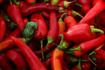 Fresh red peppers on grocery shelf ready to sell on market.