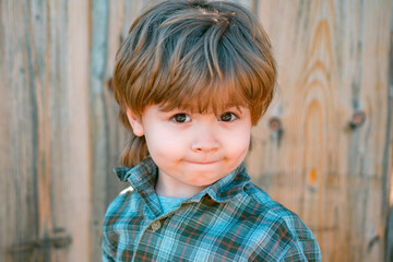 Cute spring child boy. Kids emotions. Happy kid outdoor.