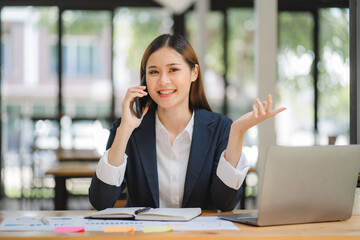 business woman or accountant who are using a calculator to calculate business data Accounting documents and laptop computer at the office business idea