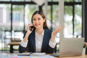 Fototapeta premium business woman or accountant who are using a calculator to calculate business data Accounting documents and laptop computer at the office business idea