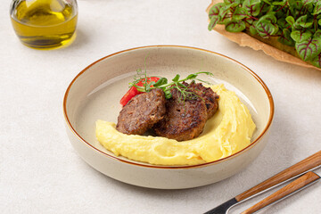 Portion of russian beef cutlets with mashed potato and herbs