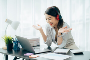 Asian woman enjoy listening to music and drinking coffee and laptop computer in the morning