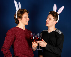 Easter, two attractive funny guys in a bunny costume. Beautiful gay couple having fun.