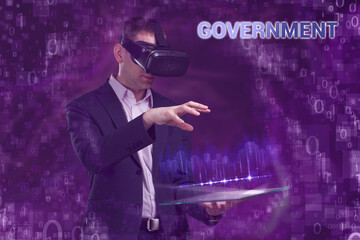 Business, Technology, Internet and network concept. Young businessman working on a virtual screen of the future and sees the inscription: Government