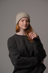 young girl model in beige hipster hat and coat isolated on light background. Product photo mockup for fashion brands and marketplaces, woolen cap, turkish textiles.