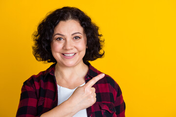 Photo of pretty mature woman dressed shirt pointing fingers empty space isolated shine color background
