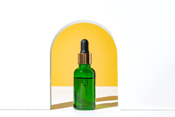 Natural skincare product in glass bottle with dropper. Serum for woman facial skin. Herbal mineral cosmetic, vitamin body oil in white arch. organic cosmetics presentation on bright yellow