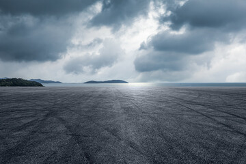 Asphalt road and lake with island nature landscape in cloudy sky - Powered by Adobe
