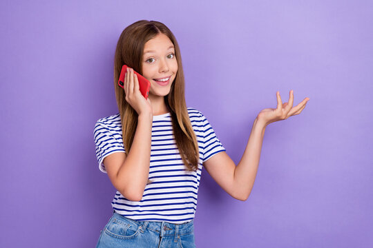 Photo Of Adorable Positive Cheerful Girl With Straight Hairdo Wear Striped T-shirt Talking On Phone Isolated On Purple Color Background