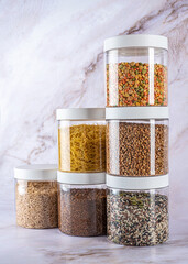 A set of transparent cans for dry food on a light background