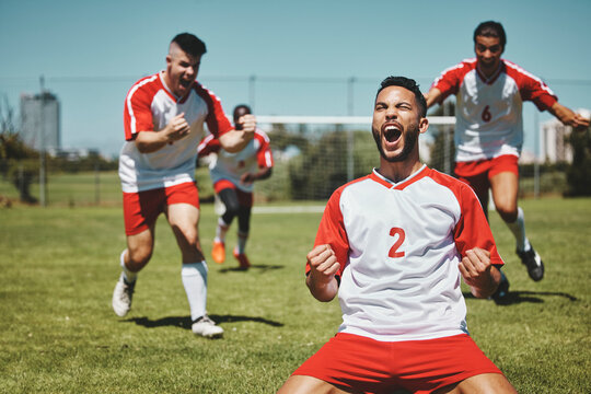 Team, success and winner by soccer player celebration during game at soccer field, happy, cheering and victory. Sport, achievement and goal by football team running and celebrating football field win