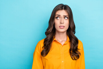 Portrait of minded unsatisfied person look interested empty space isolated on blue color background