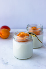 Homemade yogurt with juicy apricots. Yogurt on a white table