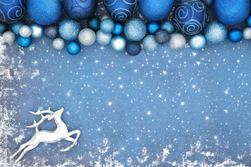 Christmas Eve north pole concept with silver reindeer and sparkling blue bauble decorations on...