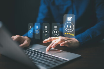 Customer service and Satisfaction concept ,feedback customer. Business people are touching virtual screen on the happy Smiley face icon to give satisfaction in service. rating very impressed.