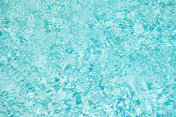 blue color background of swimming pool water with ripples in summer resort