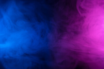 Clouds of colorful smoke in blue and purple neon light swirling on black table background with reflection - 539119027