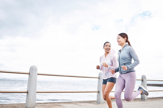 Running, fitness and women friends by ocean for outdoor wellness, accountability or workout motivation on sky mock up marketing or advertising. Sports athlete people exercise for healthy lifestyle
